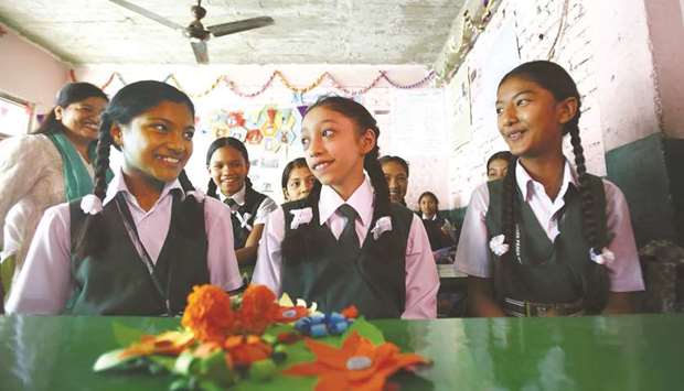 Matina Shakya, centre, sits in a classroom on her first day of school in Kathmandu yesterday.