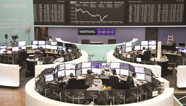 Traders at the Frankfurt Stock Exchange. The DAX 30 gained 0.3% to 11,977.22 points yesterday.