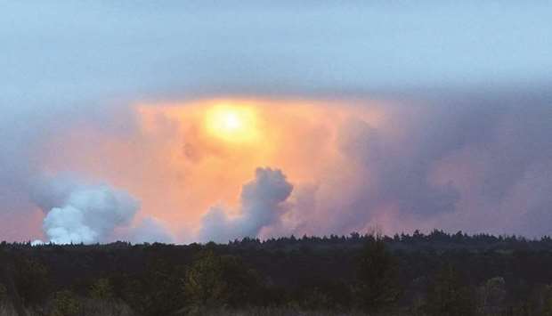 A fireball is seen in the sky from the village Zaudaika, some 8km from the epicentre of a series of explosions at an ammunition depot in Ukraineu2019s northern Chernihiv region.
