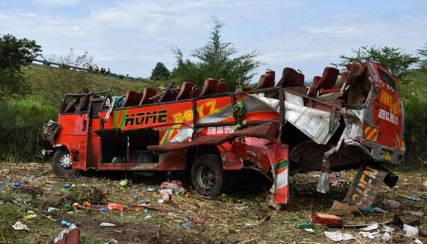 Kenyan emergency personnel and security forces inspect the wreckage of a bus at the site of an accident in Kericho, western Kenya.
