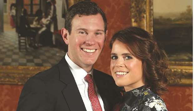 In this file photo taken on January 22, 2018 Britainu2019s Princess Eugenie of York poses with her fiance Jack Brooksbank in the Picture Gallery at Buckingham Palace in London, after the announcement of their engagement.