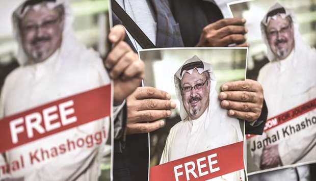 Protesters hold pictures of missing journalist Jamal Khashoggi during a demonstration in front of the Saudi Arabian consulate in Istanbul.