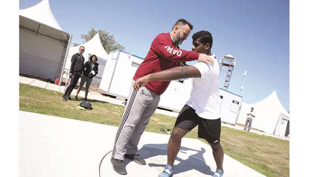 Qataru2019s Ahmad al-Haj trains with his coach in Buenos Aires yesterday.