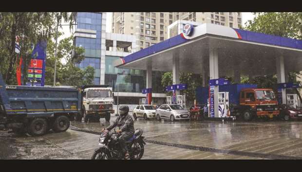 A motorcyclist exits a Hindustan Petroleum Corp gas station in Mumbai (file). India, China, Taiwan, Chile, Turkey, Egypt and Ukraine are among the nations who would take a hit. Paying more for oil will pressure current accounts and make economies more vulnerable to rising US interest rates.