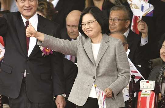 Taiwanu2019s President Tsai Ing-wen gestures as she attends National Day celebrations in front of the Presidential Palace in Taipei.