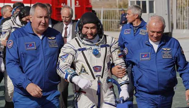 ISS crew member cosmonaut Alexey Ovchinin of Russia walks to board the Soyuz MS-10 spacecraft