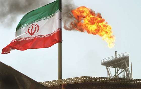 A gas flare on an oil production platform in the Soroush oil fields is seen alongside an Iranian flag (file). Efforts by the European Union to preserve the international nuclear deal with Iran by setting up a payment mechanism to circumvent US sanctions wonu2019t help oil buyers, say trading-house executives.