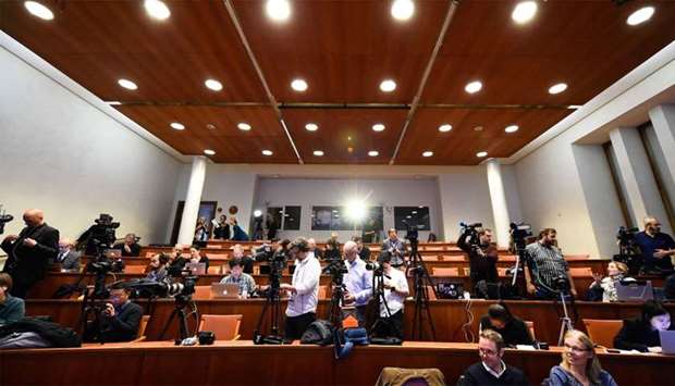 Journalists wait for the beginning of a press conference to announce the winner of the 2018 Nobel Prize in Physiology or Medicine at the Karolinska Institute in Stockholm, Sweden