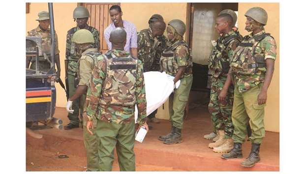 Security officers carry the body of a teacher killed at Arabia Boys Secondary School after  suspected Al Shebaab militants threw an explosive device at a teacheru2019s house in Mandera county, Kenya yesterday.