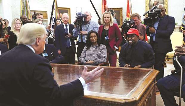 Trump speaks while West listens during a meeting in the Oval Office.