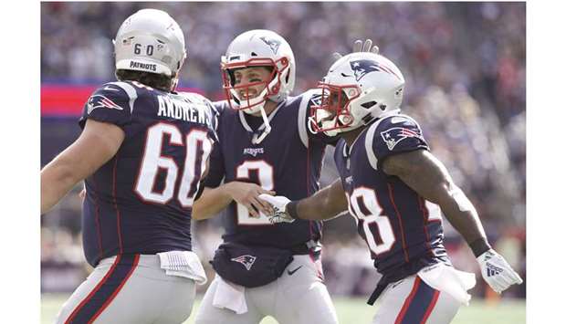 New England Patriots running back James White (right) celebrates with teammates after a touchdown against the Miami Dolphins in the first-half of their NFL game at Gillette Stadium in Foxborough, USA. PICTURE: USA TODAY Sports