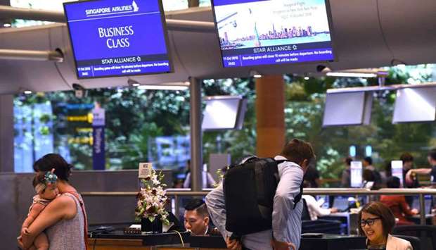 Passengers of flight SQ22, Singapore Airlines' inaugural non-stop flight to New York check-in at Changi International Airport in Singapore yesterday.
