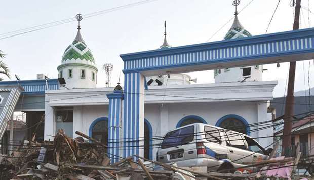 A car is seen outside a mosque after the area was hit by a tsunami, triggered by the earthquake, in Palu, Indonesiau2019s Central Sulawesi yesterday.