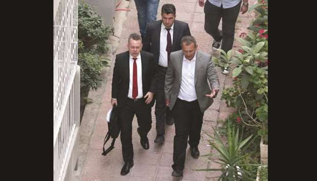 Brunson (wearing a red tie) is escorted home in Izmir yesterday after being freed following a trial in a court in Aliaga, western Izmir province.