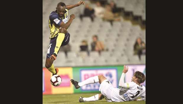 Usain Bolt, playing for A-League football club Central Coast Mariners, jumps while controlling the ball in his first competitive start for the club against Macarthur South West United in a pre-season game in Sydney yesterday. (AFP)