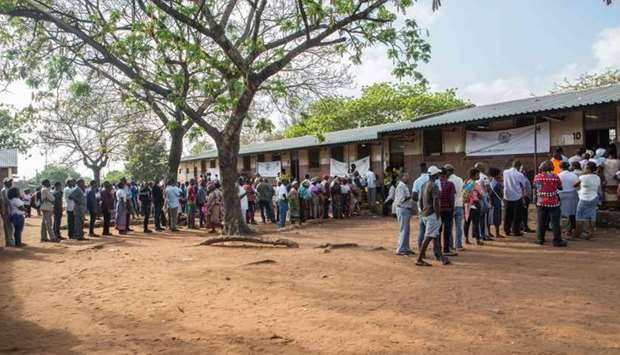 Voters wait to cast their votes for Mozambique's local elections on October 10 at a polling station in the capital Maputo.