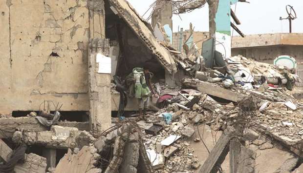 A man searches for belongings amid rubble of damaged buildings in Raqqa.