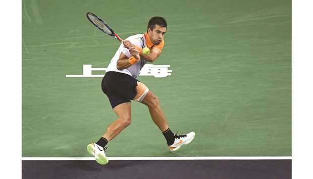 Croatiau2019s Borna Coric hits a return against Switzerlandu2019s Roger Federer during their Shanghai Masters semi-final yesterday. (AFP)