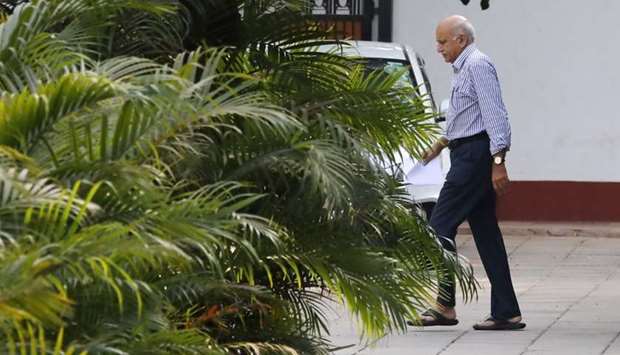 India's Minister of State for External Affairs Mobashar Jawed Akbar walks inside his residence in New Delhi. Reuters