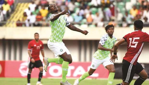 Nigerian forward Odion Ighalo (centre) heads to control the ball during the African Cup of Nations qualification match against Libya in Uyo, southern Nigeria, on Saturday night. (AFP)