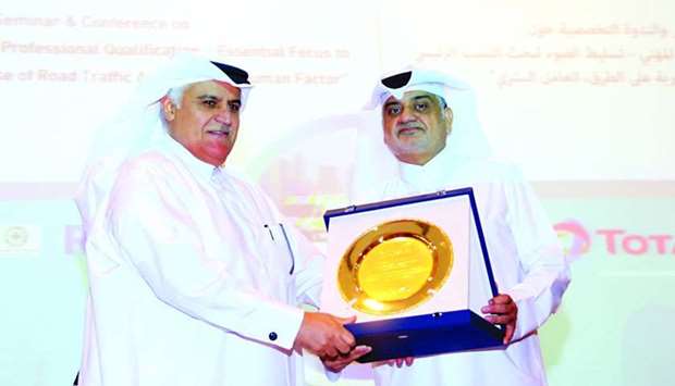Mowasalat's Nasser bin Mohamed al-Malki honouring National Traffic Safety Committee's Brigadier Mohamed Abdullah al-Malki at the conference.