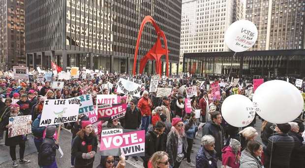 People hold signs during a rally in Chicago on Saturday to inspire voter turnout ahead of midterm polls in the United States.