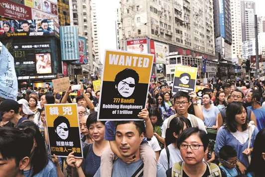 Protesters mock Hong Kong Chief Executive Carrie Lam as they demonstrate against a large-scale land reclamation to build artificial islands in Hong Kong, China.