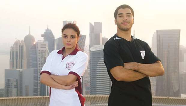 Team Qataru2019s gymnasts Jana al-Kiki (left) and Ahmed Nabil.