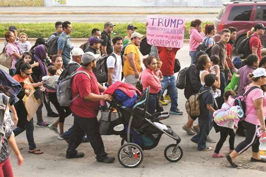 Hondurans walk towards the US from San Pedro Sula, 180km north from Tegucigalpa, on Saturday.