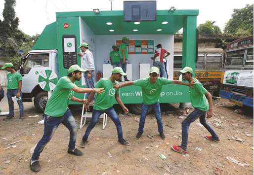 WhatsApp-Reliance Jio representatives perform in a street play during a drive by the two companies to educate users, on the outskirts of Kolkata.