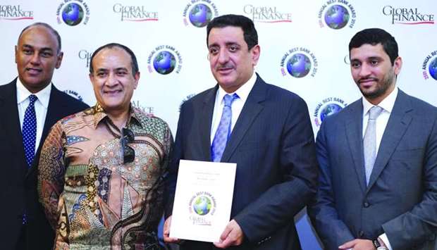 Commercial Bank board member Mohamad Ismail Mandani (second right) and Abraham (second left) with other bank executives at the Global Finance magazine awards ceremony in Bali, Indonesia recently where the bank received the u2018Best Bank in Qataru2019 honour.