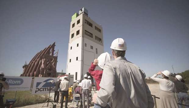 BIG SHAKE: Spectators take a look at a five-story building that was constructed on UC San Diegou2019s big shake table in Scripps Ranch, shortly before the structure was shaken hard during an earthquake simulation.