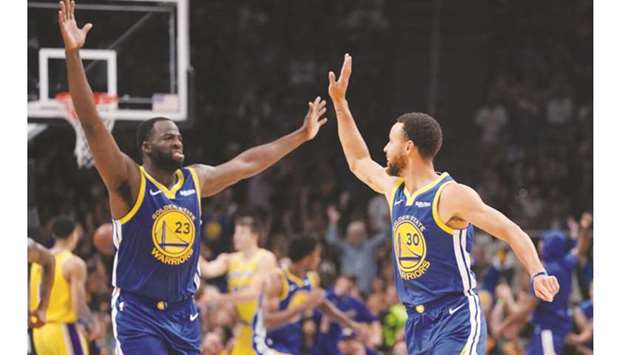 Golden State Warriorsu2019 Draymond Green (left) and teammate Stephen Curry celebrate during the game against LA Lakers in San Jose,California, on Friday. (USA TODAY Sports)
