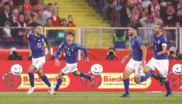 Italyu2019s Cristiano Biraghi (left) celebrates with teammates after scoring against Poland in the  UEFA Nations League match  at Silesian Stadium in Chorzow, Poland, on Sunday night. (Reuters)