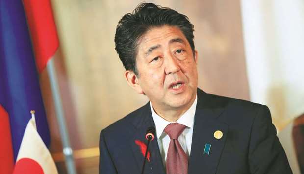 Japanese Prime Minister Shinzo Abe attends a news conference in Tokyo. Abe said the  government will consider tax breaks for durable goods purchases, such as cars and homes, and come up with a scheme to ease the burden on small companies and small retailers once the sales tax is raised to 10% from 8%.