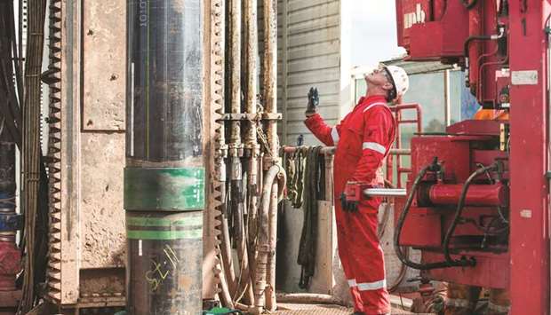 A worker monitors sections of pipe as they are lowered on the drilling platform at the Preston New Road pilot gas well site, operated by Cuadrilla Resources, near Blackpool, UK (file). Cuadrilla, 47.4% owned by Australiau2019s AJ Lucas and 45.2% owned by a fund managed by Riverstone, said it would spend at least three months fracking two horizontal wells to test flow rates to determine whether full-scale gas extraction would be viable.