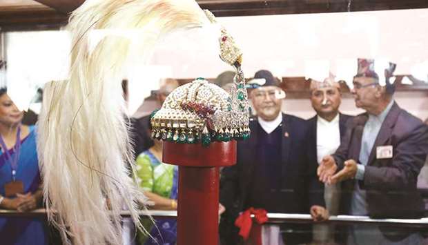 Nepal Prime Minister KP Sharma Oli observes the royal crown of former monarchs of Nepal, placed inside a bulletproof box at Narayanhiti Palace Museum in Kathmandu yesterday.