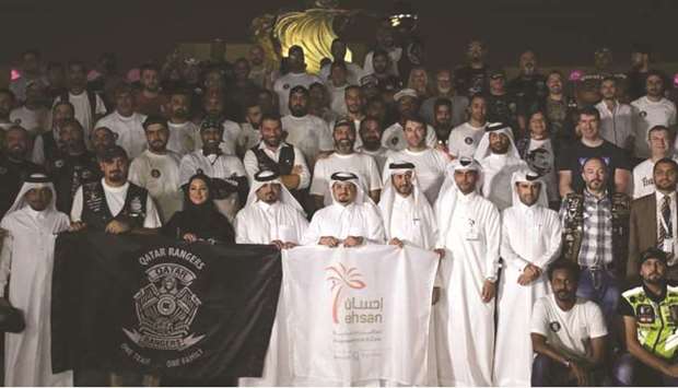 Ehsan Centre staff and Qatar Rangers Bikers pose for a commemorative photo during the event on Friday.