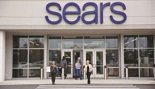 Shoppers exit a newly renovated Sears Holdings store in Oak Brook, Illinois. Sears filed for Chapter 11 protection from creditors with the US Bankruptcy Court in White Plains, New York, early yesterday and said Eddie Lampert is stepping down immediately as chief executive officer.