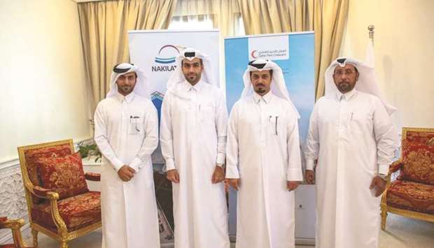 Nakilat and Qatar Red Crescent Society officials.