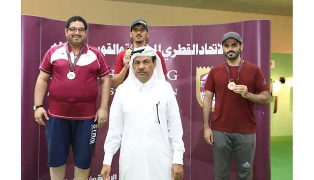 Menu2019s 25m pistol gold medallist Ahmed al-Shammari (rear, centre) poses with silver medallist Riad Rustom (rear, left), bronze medallist Osama al-Shaibah (rear, right) and Organising Committee chairman Majid al-Nuaimi (foreground).