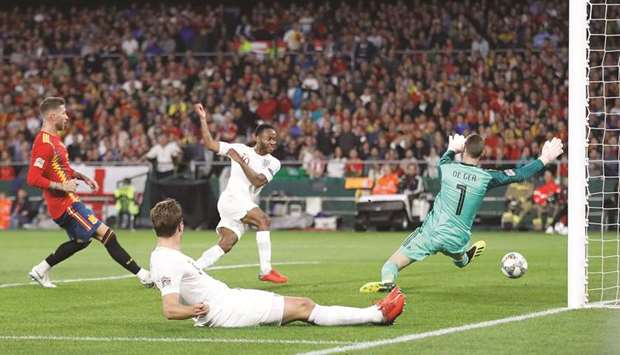 Englandu2019s Raheem Sterling (second right) scores past Spain goalkeeper David De Gea during the UEFA Nations League match at the Estadio Benito Villamarin in Seville, Spain, on Monday. (Reuters)
