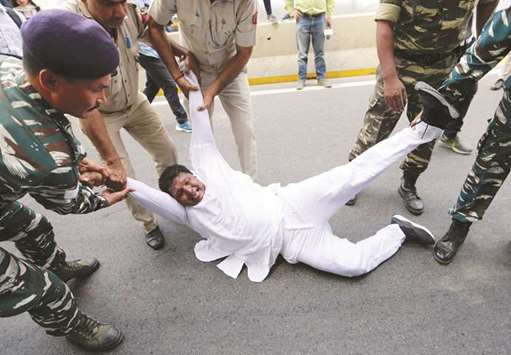 Police detain a supporter of the main opposition Congress Party during a protest demanding the resignation of Minister of State for External Affairs M J Akbar in New Delhi.