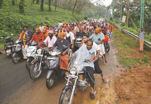 Hindu devotees take part in a motorcycle rally as part of a protest against the lifting of a ban by Supreme Court that allowed entry of women to the Sabarimala temple, at Nilakkal base camp in Pathanamthitta district in Kerala yesterday.