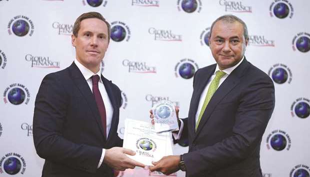 QIB Group CEO Bassel Gamal receiving the awards from Global Finance.