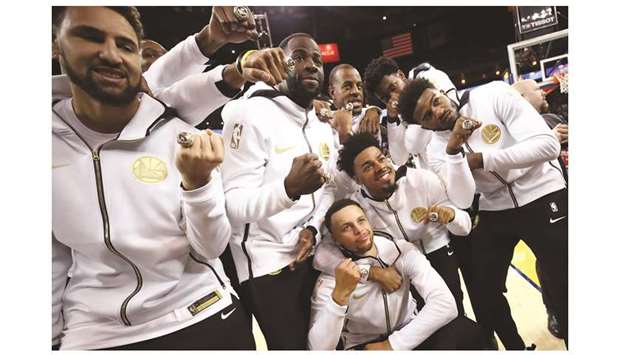 Golden State Warriors players celebrate after receiving their 2017-2018 Championship rings prior to their game against the Oklahoma City Thunder in Oakland, California, on Tuesday. (AFP)