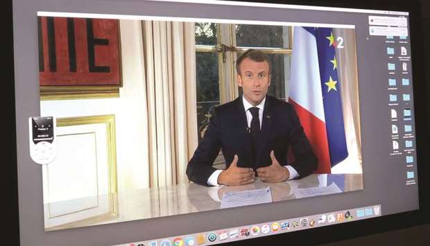 Macron, seen in this pre-recorded message, speaks to the nation on prime time  television from the Elysee Palace in Paris.