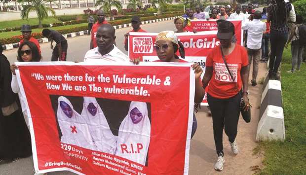 Members of the Bring Back Our Girls (BBOG) advocacy group take part in a protest in the Nigerian capital Abuja yesterday following the killing of a kidnapped female Red Cross worker by Islamic State-allied Boko Haram extremists.