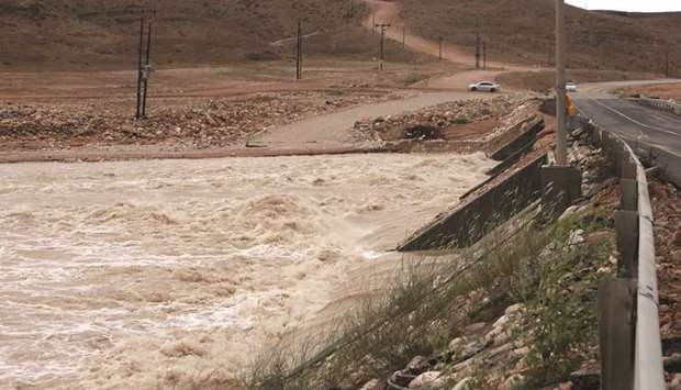 A picture shows flooded streets in the Adonab valley near Salalah, in the southern Omani province of Dhofar, during the tropical storm Luban.
