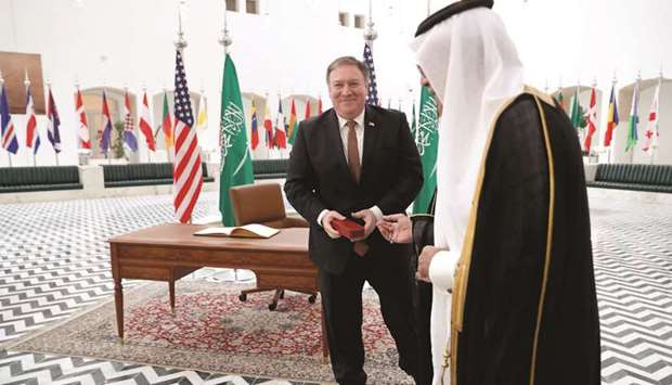 US Secretary of State Mike Pompeo receives a gift during a visit to the Saudi capital  Riyadh yesterday. Pompeo held talks with Saudi King Salman seeking answers about the disappearance of journalist Jamal Khashoggi, amid US media reports the kingdom may be mulling an admission he died during a botched interrogation.